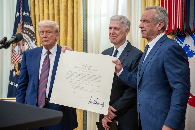 President Donald Trump and RFK Jr signing a bill at the White House 02/13/25